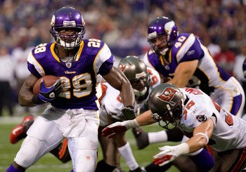 MINNEAPOLIS, MN - SEPTEMBER 18: Adrian Peterson #28 of the Minnesota Vikings avoids a tackle by Cody Grimm #35 of the Tampa Bay Buccaneers in the second quarter on September 18, 2011 at Hubert H. Humphrey Metrodome in Minneapolis, Minnesota. Peterson scor