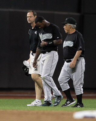 NEW YORK, NY - AUGUST 02:  Hanley Ramirez #2 of the Florida Marlins is helped from the field after injuring himself in the sixth inning against the New York Mets at Citi Field on August 2, 2011 in the Flushing neighborhood of the Queens borough of New Yor
