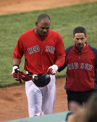 BOSTON, MA  - JUNE 17:  Carl Crawford #13 of the Boston Red Sox leaves the game in the first inning after an injury against the Milwaukee Brewers at Fenway Park on June 17, 2011 in Boston, Massachusetts.  (Photo by Jim Rogash/Getty Images)