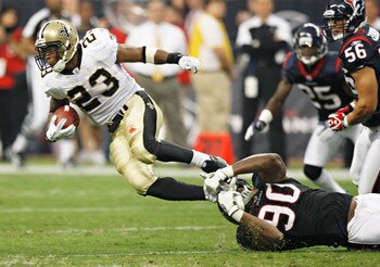 HOUSTON - AUGUST 20:  Running back Pierre Thomas #23 of the New Orleans Saints is tackled by linebacker Mario Williams #90 at Reliant Stadium on August 20, 2011 in Houston, Texas.  (Photo by Bob Levey/Getty Images)