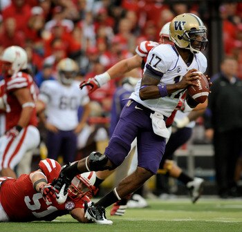 LINCOLN, NE - SEPTEMBER 17: Keith Price #17 of the Washington Huskies scans down field while avoiding J.C. Moore #52 of the Nebraska Cornhuskers during their game at Memorial Stadium September 17, 2011 in Lincoln, Nebraska. Nebraska won 51-38.(Photo by Er