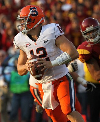 LOS ANGELES, CA - SEPTEMBER 17:  Quarterback Ryan Nassib #12 of the Syracuse Orangemen rolls out against the USC Trojans at the Los Angeles Memorial Coliseum on September 17, 2011 in Los Angeles, California.  USC won 38-17.  (Photo by Stephen Dunn/Getty I