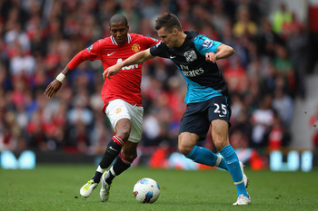 MANCHESTER, ENGLAND - AUGUST 28:  Ashley Young of Manchester United and Carl Jenkinson of Arsenal battle for the ball during the Barclays Premier League match between Manchester United and Arsenal at Old Trafford on August 28, 2011 in Manchester, England.