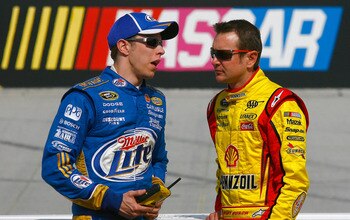 BRISTOL, TN - MARCH 18:  Brad Keselowski (L), driver of the #2 Miller Lite Dodge, talks with Kurt Busch (R), driver of the #22 Shell/Pennzoil Dodge, on the grid during qualifying for the NASCAR Sprint Cup Series Jeff Byrd 500 Presented By Food City at Bri