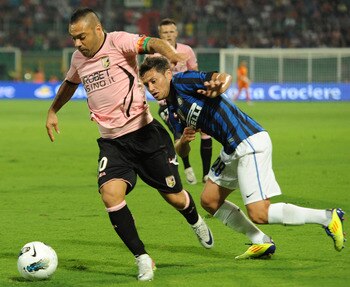 PALERMO, ITALY - SEPTEMBER 11:  Fabrizio Miccoli (L) of Palermo and Mauro Zarate of Inter compete for the ball during the Serie A match between US Citta di Palermo and FC Internazionale Milano at Stadio Renzo Barbera on September 11, 2011 in Palermo, Ital