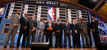 NEWARK, NJ - JUNE 23:  The 2011 Draft class including Kyrie Irving, Derrick Williams, Enes Kanter, Jonas Valanciunas, Brandon Knight, Jimmer Fredette and Kemba Walker pose for a group photo with NBA Commissioner David Stern (C) during the 2011 NBA Draft a