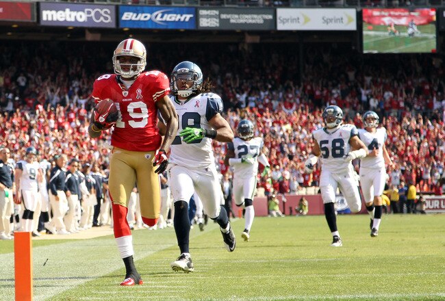 SAN FRANCISCO, CA - SEPTEMBER 11:  Ted Ginn #19 of the San Francisco 49ers outruns Earl Thomas #29 and the rest of the Seattle Seahawks on his way to scoring a touchdown on a kickoff return during their season opener at Candlestick Park on September 11, 2