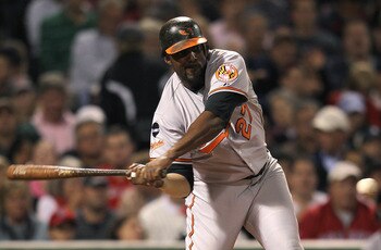 BOSTON, MA - SEPTEMBER 20:   Vladimir Guerrero #27 of the Baltimore Orioles slaps the ball to right field where Josh Reddick #16 of the Boston Red Sox (not pictured) mishandled a fly ball in the third inning at Fenway Park September 20, 2011 in Boston, Ma