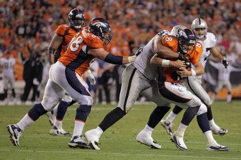 DENVER, CO - SEPTEMBER 12:  Quarterback Kyle Orton #8 of the Denver Broncos is sacked by defensive tackle  Richard Seymour #92 of the Oakland Raiders in the third quarterat Sports Authority Field at Mile High on September 12, 2011 in Denver, Colorado. The