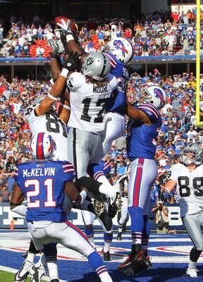 ORCHARD PARK, NY - SEPTEMBER 18: Da'Norris Searcy #25 of the Buffalo Bills catches an interception on the last play of the game during an NFL game as Denarius Moore #17 of the Oakland Raiders tres to catch the hail mary pass at Ralph Wilson Stadium on Sep