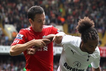 LONDON, ENGLAND - SEPTEMBER 18:  Stewart Downing of Liverpool challenges Benoit Assou Ekotto of Tottenham Hotspur for the ball during the Barclays Premier League match between Tottenham Hotspur and Liverpool at White Hart Lane on September 18, 2011 in Lon