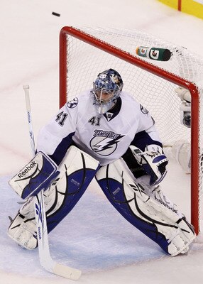BOSTON, MA - MAY 23:  The puck flies high of the goal as Mike Smith #41 of the Tampa Bay Lightning defends against the Boston Bruins in Game Five of the Eastern Conference Finals during the 2011 NHL Stanley Cup Playoffs at TD Garden on May 23, 2011 in Bos