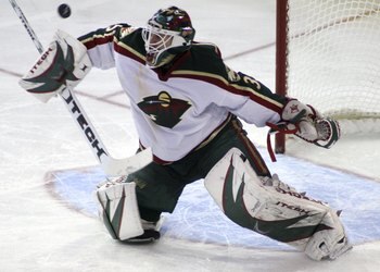 EDMONTON, CANADA - JANUARY 12:  Goalie Manny Fernandez #35 of the Minnesota Wild deflects a shot on net with his blocker during the third period at Rexall Place January 12, 2007 in Edmonton, Canada. The Wild defeated the Oilers 4-2.  (Photo by Tim Smith/G