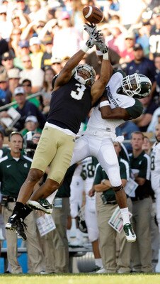 SOUTH BEND, IN - SEPTEMBER 17:  Michael Floyd #3 of the Notre Dame Fighting Irish tries to catch the ball while being covered by Johnny Adams #5 of the Michigan State Spartans during the second half September 17, 2011at Notre Dame Stadium in South Bend, I