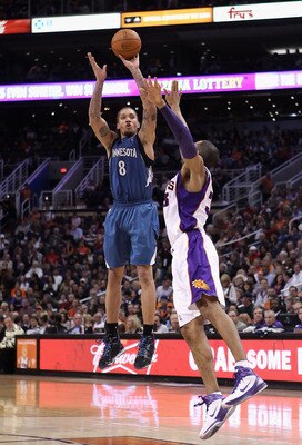 PHOENIX - DECEMBER 15:  Michael Beasley #8 of the Minnesota Timberwolves puts up a shot over Grant Hill #33 of the Phoenix Suns during the NBA game at US Airways Center on December 15, 2010 in Phoenix, Arizona. NOTE TO USER: User expressly acknowledges an