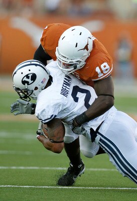 AUSTIN, TX - SEPTEMBER 10: Linebacker Emmanuel Acho #18 of  the Texas Longhorns tackles wide receiver Cody Hoffman #2 of the BYU Cougars on September 10, 2011 at Darrell K. Royal-Texas Memorial Stadium in Austin, Texas.  Texas defeated BYU 17-16. (Photo b