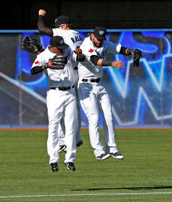 TORONTO, CANADA - SEPTEMBER 18: Jose Bautista #19, Colby Rasmus #28, and Dewayne Wise #3 of the Toronto Blue Jays celebrate 3-0 win against the New York Yankees during MLB action at the Rogers Centre September 18, 2011 in Toronto, Ontario, Canada. (Photo