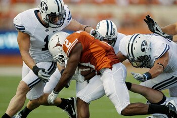 AUSTIN, TX - SEPTEMBER 10:  Running back Fozzy Whittaker #2 of the Texas Longhorns is tackled in the first quarter by linebacker Jordan Pendleton #1, defensive back Daniel Sorensen #9, and linebacker Uona Kaveinga #4 of the BYU Cougars on September 10, 20