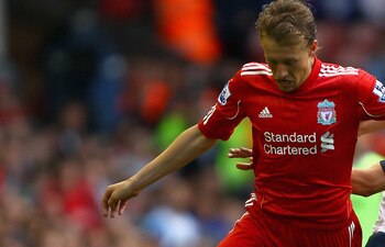 LIVERPOOL, ENGLAND - AUGUST 27:  Leiva Lucas of Liverpool is tackled by Ivan Klasnic of Bolton Wanderers looks on during the Barclays Premier League match between Liverpool and Bolton Wanderers at Anfield on August 27, 2011 in Liverpool, England.  (Photo