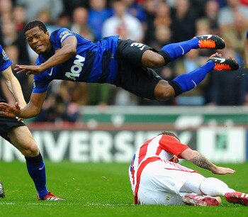 STOKE ON TRENT, ENGLAND - SEPTEMBER 24:  Patrice Evra of Manchester United flies in the air as he is tackled by Glenn Whelan of Stoke City during the Barclays Premier League match between Stoke City and Manchester United at the Britannia Stadium on Septem