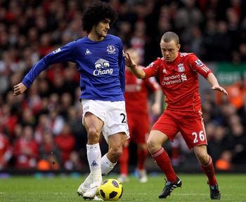 LIVERPOOL, ENGLAND - JANUARY 16:  Marouane Fellaini of Everton is challenged by Jay Spearing of Liverpool during the Barclays Premier League match between Liverpool and Everton at Anfield on January 16, 2011 in Liverpool, England. (Photo by Alex Livesey /