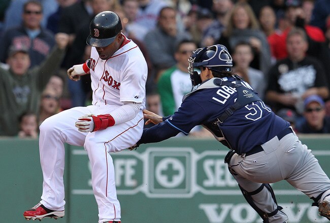BOSTON, MA - SEPTEMBER 17:  Carl Crawford #13 of the Boston Red Sox is safe at home as Jose Lobaton #31 of the Tampa Bay Rays applies a late tag in the third inning at Fenway Park September 17, 2011 in Boston, Massachusetts. (Photo by Jim Rogash/Getty Ima