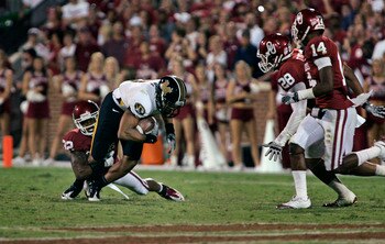 NORMAN, OK - SEPTEMBER 24: Defensive back Jamell Fleming #32  of the Oklahoma Sooners tackles wide receiver Wes Kemp #8 of the Missouri Tigers during the second half on September 24, 2011 at Gaylord Family-Oklahoma Memorial Stadium in Norman, Oklahoma.  O