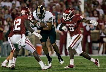 NORMAN, OK - SEPTEMBER 24:  Quarterback James Franklin #1 of the Missouri Tigers tries to rush past defensive back Lynn Gabe #9  of the Oklahoma Sooners during the second half September 24, 2011 at Gaylord Family-Oklahoma Memorial Stadium in Norman, Oklah