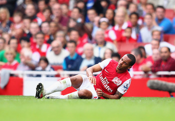 LONDON, ENGLAND - SEPTEMBER 24:  Theo Walcott of Arsenal falls down with an injury during the Barclays Premier League match between Arsenal and Bolton Wanderers at Emirates Stadium on September 24, 2011 in London, England.  (Photo by Clive Mason/Getty Ima