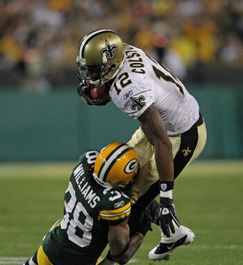 GREEN BAY, WI - SEPTEMBER 08: Marques Colston #12 of the New Orleans Saints is tackled by Tramon Williams #38 of the Green Bay Packers during the NFL opening season game at Lambeau Field on September 8, 2011 in Green Bay, Wisconsin. The Packers defeated t