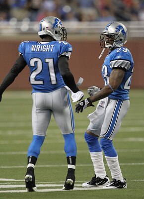 DETROIT - AUGUST 12:  Chris Houston #23 of the Detroit Lions celebrates with teammate Eric Wright #21 after intercepting a pass from Andy Dalton #14 of the Cincinnati Bengals in the first quarter of the game at Ford Field on August 12, 2011 in Detroit, Mi