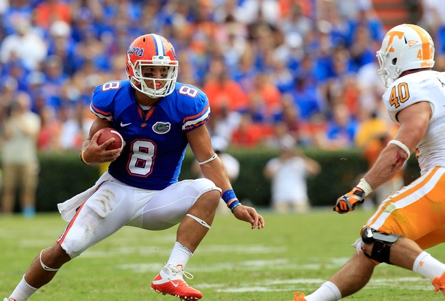 GAINESVILLE, FL - SEPTEMBER 17:  Trey Burton #8 of the Florida Gators attempts turnover run past linebacker Austin Johnson #40 of the Tennessee Volunteers  during a game at Ben Hill Griffin Stadium on September 17, 2011 in Gainesville, Florida.  (Photo by