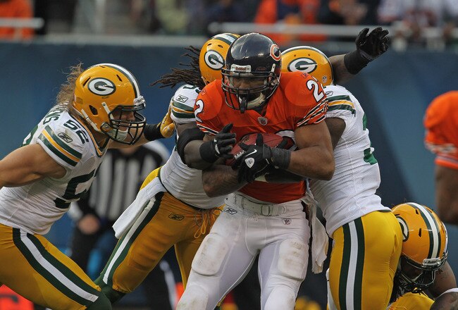 CHICAGO, IL - SEPTEMBER 25: Matt Forte #22 of the Chicago Bears is tackled by (L-R) Clay Matthews #52, Erik Walden #93, Sam Shields #37 and Morgan Burnett #42 of the Green Bay Packers at Soldier Field on September 25, 2011 in Chicago, Illinois. The Packer