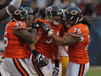 CHICAGO, IL - SEPTEMBER 25: Brian Urlacher #54 of the Chicago Bears celebrates an interception with teammates Anothny Adams #95 and Matt Toeaina #75 against the Green Bay Packers at Soldier Field on September 25, 2011 in Chicago, Illinois. The Packers def