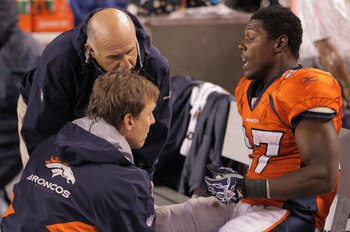DENVER, CO - SEPTEMBER 12:  Running back  Knowshon Moreno #27 of the Denver Broncos is attended to on the bench late in the fourth quarter against the Oakland Raiders at Sports Authority Field at Mile High on September 12, 2011 in Denver, Colorado. The Ra
