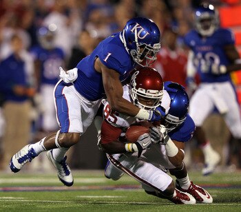 LAWRENCE, KS - OCTOBER 15:  Ryan Broyles #85 of the Oklahoma Sooners is tackled after making a catch by Lubbock Smith #1 and Tyler Patman #33 of the Kansas Jayhawks during the game on October 15, 2011 at Memorial Stadium in Lawrence, Kansas.  (Photo by Ja