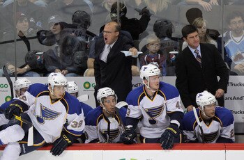 This photo presents two questions: What's on the their left? Why isn't Davis Payne looking at it?