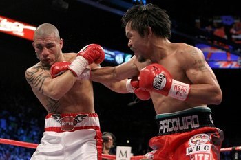 Cotto (left) being pummeled by Pacquiao.