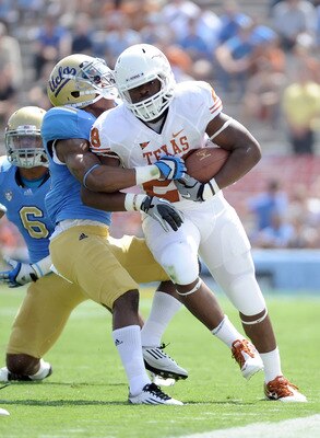 PASADENA, CA - SEPTEMBER 17:  Malcolm Brown #28 of the Texas Longhorns is tackled by Andrew Abbott #26 of the UCLA Bruins during the game at Rose Bowl on September 17, 2011 in Pasadena, California.  (Photo by Harry How/Getty Images)