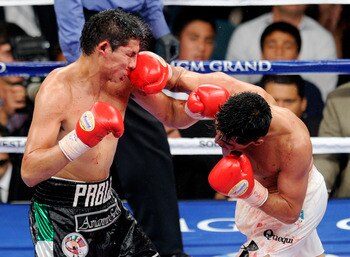 Erik Morales (right) brings the pain to his younger foe.