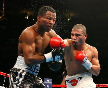 Shane Mosley receives some of that "New York Magic" from Cotto.