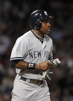 BOSTON, MA - SEPTEMBER 1: Curtis Granderson #14 of the New York Yankees jogs to first in the sixth inning against the Boston Red Sox at Fenway Park on September 1, 2011 in Boston, Massachusetts. The Yankees won the game 4-2. (Photo by Darren McCollester/G
