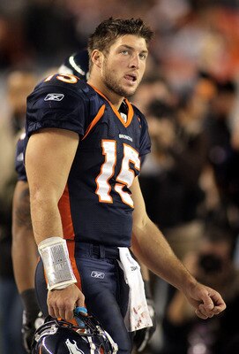 DENVER, CO - DECEMBER 18: Tim Tebow #15 of the Denver Broncos can only watch on the final moments against the New England Patriots on December 18, 2011 during the second half at Sports Authority Field at Mile High in Denver, Colorado. The New England Patr