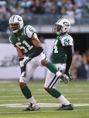 EAST RUTHERFORD, NJ - OCTOBER 23:  Darrelle Revis #24 of the New York Jets celebrates a fourth quarter interception with teammate Aaron Maybin #51 against the San Diego Chargers at MetLife Stadium on October 23, 2011 in East Rutherford, New Jersey.  (Phot