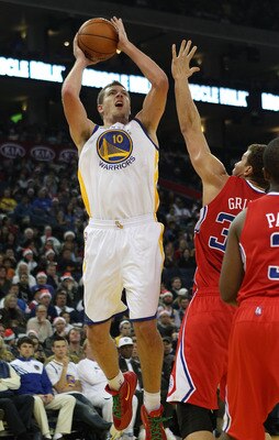 OAKLAND, CA - DECEMBER 25:  David Lee #10 of the Golden State Warriors shoots against the Blake Griffin #32 of the Los Angeles Clippers during the season opener at Oracle Arena on December 25, 2011 in Oakland, California.  NOTE TO USER: User expressly ack