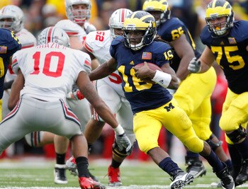ANN ARBOR, MI - NOVEMBER 26: Denard Robinson #16 of the Michigan Wolverines tries to get around the tackle of Ryan Shazier #10 of the Ohio State Buckeyes at Michigan Stadium on November 26, 2011 in Ann Arbor, Michigan. Michigan won the game 40-34. (Photo 
