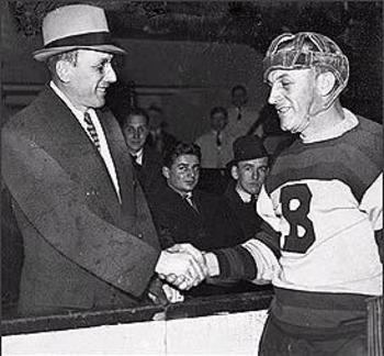 Ace Bailey (left) shakes hands with Eddie Shore, the man who ended his career.