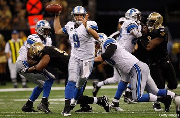 Stafford eludes pressure in order to attempt a pass...