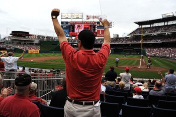 WASHINGTON, DC - SEPTEMBER 25: A fan celebrates after Wilson Ramos #3 of the Washington Nationals (not pictured) hits a homerun against the Atlanta Braves in the fourth inning at Nationals Park on September 25, 2011 in Washington, DC. The Washington Natio