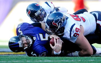 Joe Flacco is sacked by J.J Watt, one of the many times he was forced into making bad plays by the Texans defense.